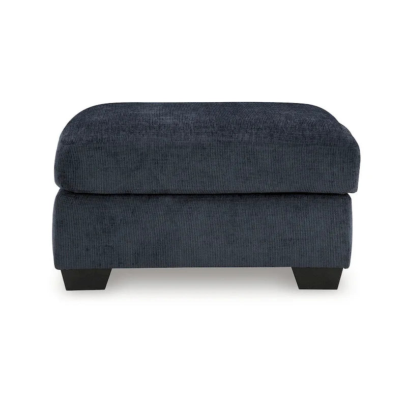 Pouf poggiapiedi di grandi dimensioni rivestito con piedini a vista in simil-legno